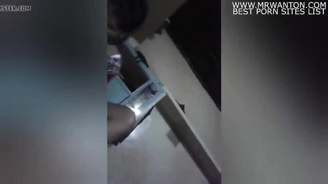 Blurry closeup of dark hand holding cash stack in dim amateur scene