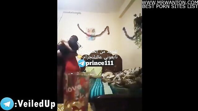 Veiled Egyptian wife in red dress hugs husband on bed amateur video