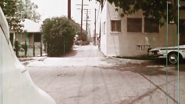 Vintage 70s porn street scene with white car and houses