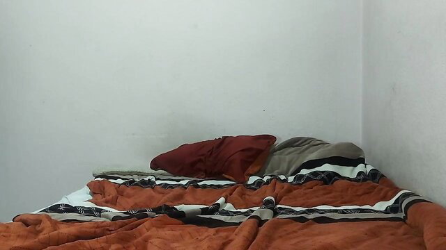 Young homeless teen on messy bed with red pillow, innocent amateur