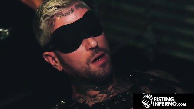 Ryan Sebastian blindfolded, tattooed sub in leather harness from Falcon Studios