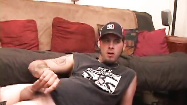 Skater Boy Elijah strokes his cock on couch in tank top