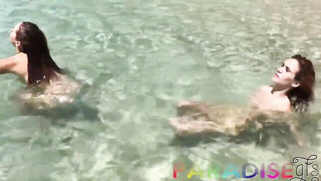 Twin sisters nude in turquoise pool water, wet bodies on vacation