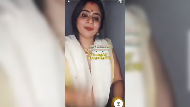 Indian Nila Nambiar in white saree blouse, smiling closeup