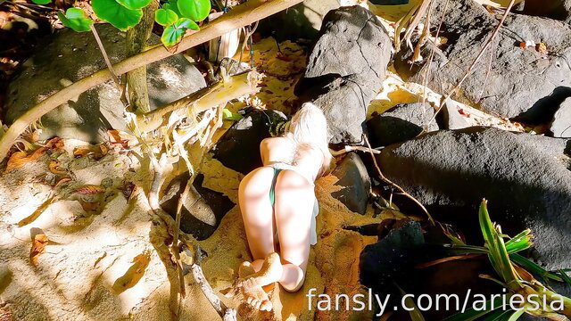 Tysria Ariesia in thong bends over Kauai rocks, arousing ASMR tease
