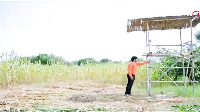 Woman in orange shirt near structure