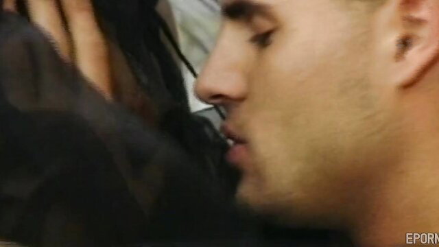 Vintage office sex closeup: man kissing busty black-haired MILF