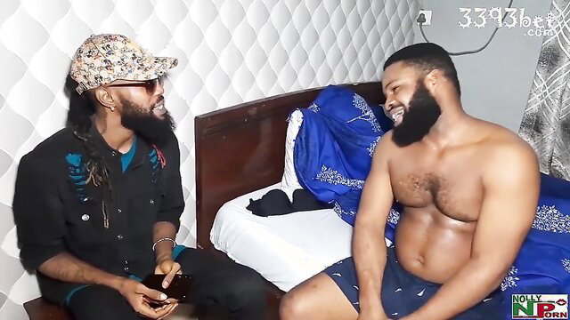 Two horny black men chatting shirtless on bed in amateur smut scene