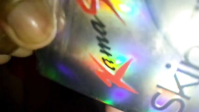 X69 holographic skin sticker closeup on finger, Nepali amateur model