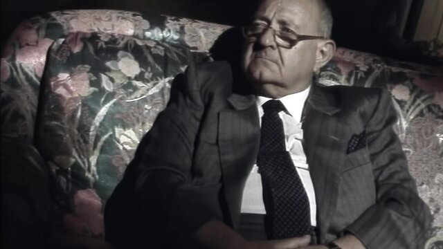 Selen De Rosa as mature Concetta Licata in elegant suit, seductive pose