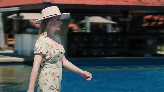 Blonde Emily Tennant in floral dress by pool, Influencer (2022)