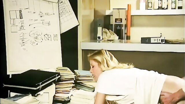 Vintage blonde bombshell in doggy pose on office desk