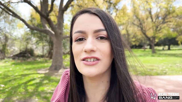 Summer Renee smiling POV in park, pink top, long dark hair