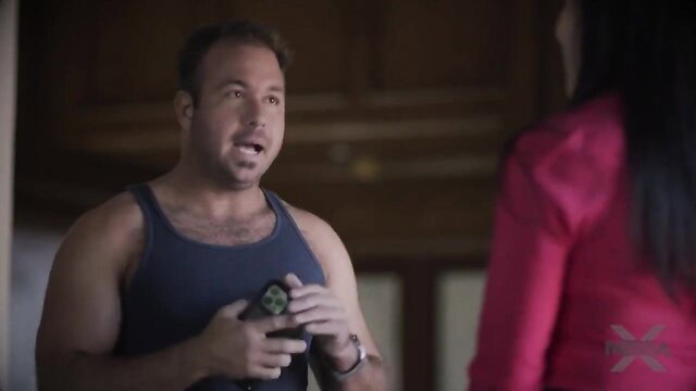 Tina in Momm's Free Pass holds green device, tank top tease