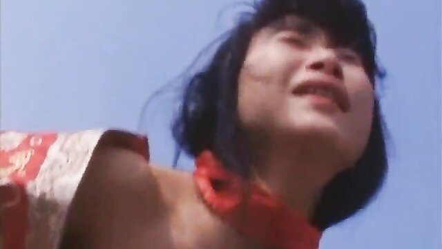 Julie Lee in Julie Lee Trilogy of Lust 1995, smiling Asian beauty in red sexy dress