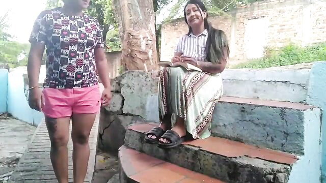 Gypsy woman in skirt sits smiling with man on street steps outdoor tease
