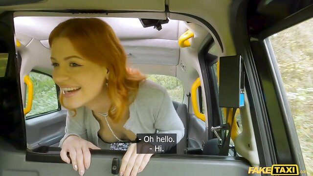 Redhead Mia Stone smiles seductively from Fake Taxi window