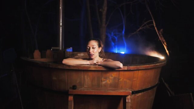 Laura Quest mixed-race beauty relaxes nude in steamy outdoor hot tub