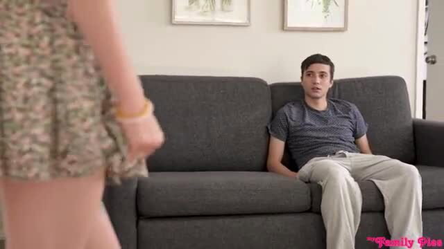 Haley Reed stands over Ricky Spanish on couch in Family Pies
