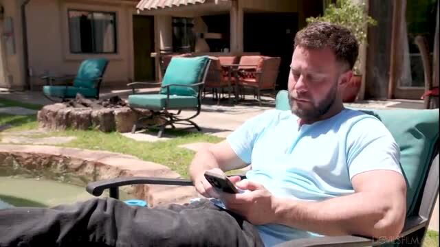 Seth Gamble lounging muscular by pool in tight shirt