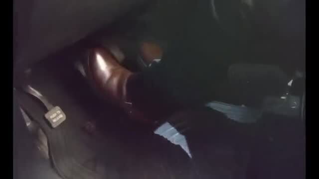 Maggy's brown dress shoe on car pedals in dark foot fetish scene