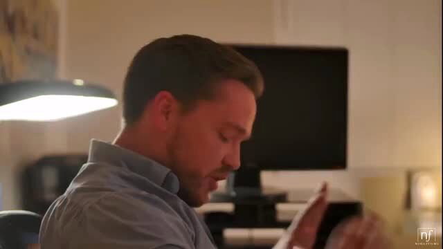 Handsome man in office shirt at desk in steamy adult scene
