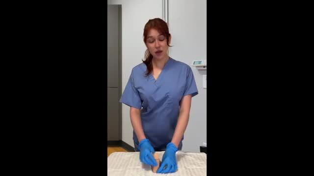 Redhead nurse Coco Mars in scrubs and blue gloves JOI tease