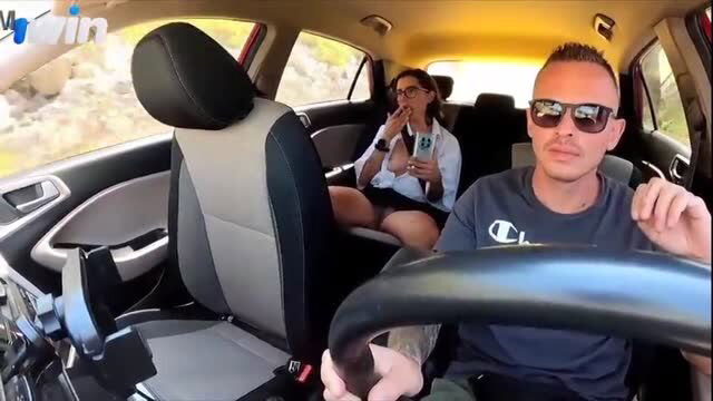 Female passenger with exposed breasts in backseat of taxi with male driver