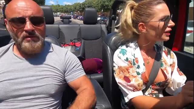 Tattooed man and blonde woman in car, stepdad fantasy scene