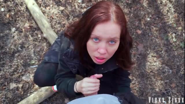 Redhead blue-eyed girl outdoors kneeling in forest POV blowjob scene