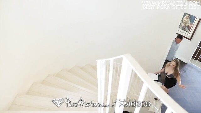 Kagney Linn Karter in tight dress on stairs in Pure Mature house sex scene