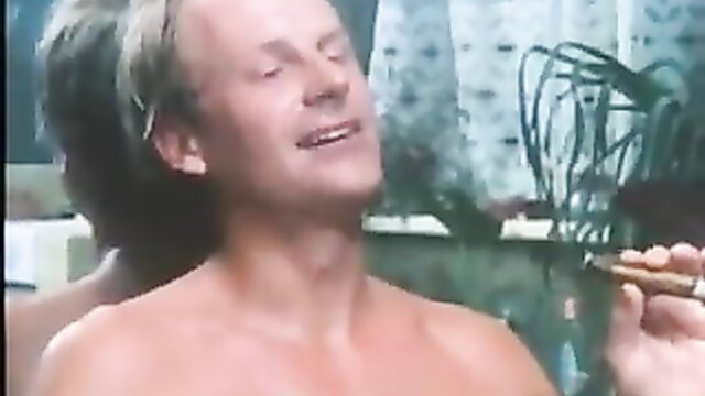 Blond German man nude smoking cigar in 70s classic adult scene