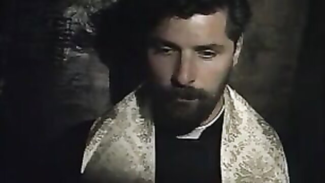 Handsome bearded priest in clerical collar and tallit, dark ancient temple vibe