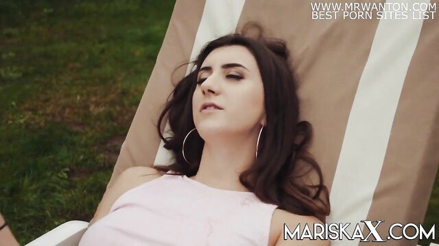 Lina Luxa French teen relaxing on lounge chair in pink top