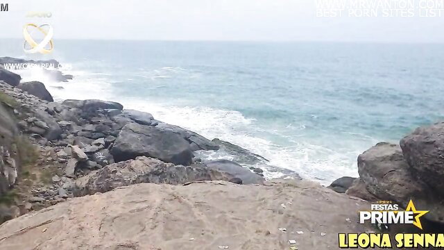 Leona Senna on Rio beach rocks, ocean waves crashing, adult video thumbnail
