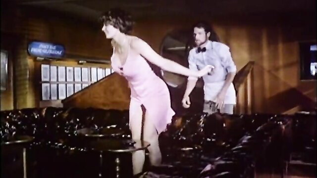 Brunette in pink dress pulled by man in bar, hot retro tease
