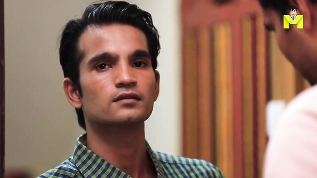 Handsome Indian delivery boy in checkered shirt, intense gaze