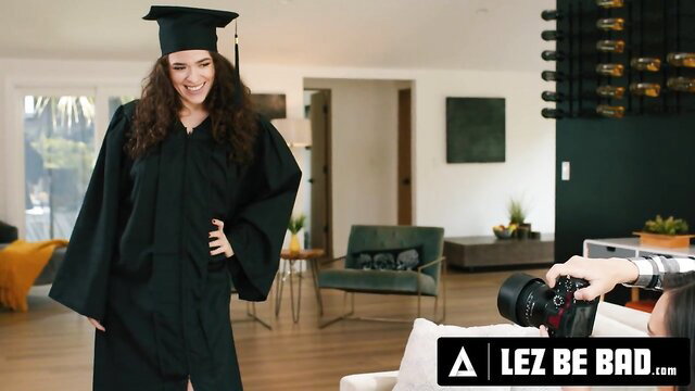 Victoria Voxxx in graduation gown at photoshoot with Sinn Sage