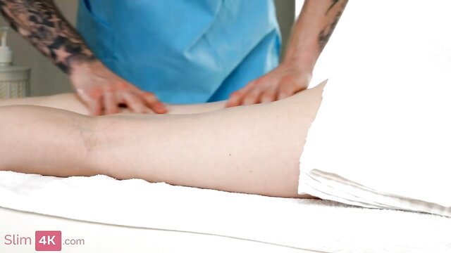 Belinda Bee blonde legs spread by tattooed masseur in blue scrubs