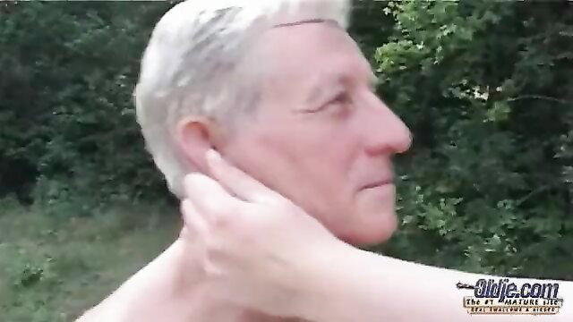 Busty Tiana Wolf gropes neck of nude old man in woods