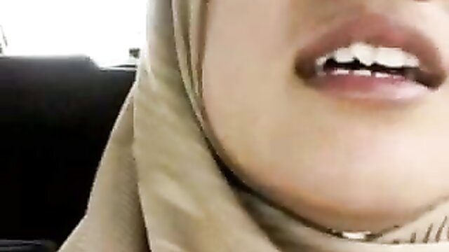 Conservative hijab girl with braces smirks seductively, teasing innocence