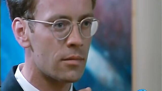 Handsome man in glasses smirking in suit, closeup portrait