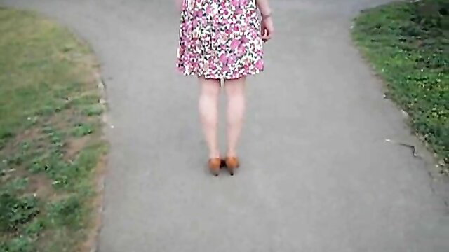 Pale wife flaunts floral summer dress, teasing ass on path