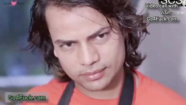 Wet-haired Indian guy in orange shirt smirks intensely in steamy photo shoot