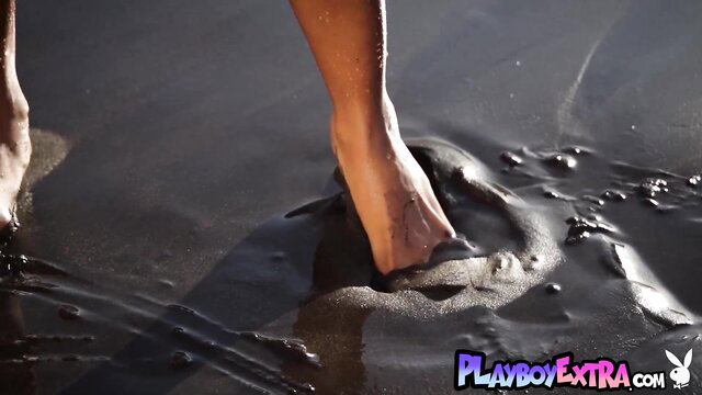 Naked ebony babe Jossa Nova's sexy feet in sand with nipple piercings