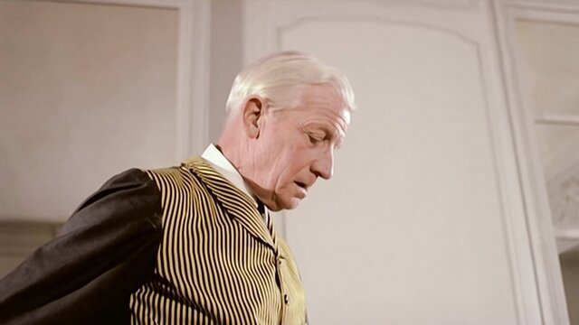 Brigitte Lahaie in elegant yellow striped vest, classic French adult scene