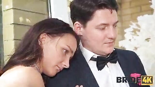 Brunette bride nuzzles groom in tux at weird wedding - Bride4K