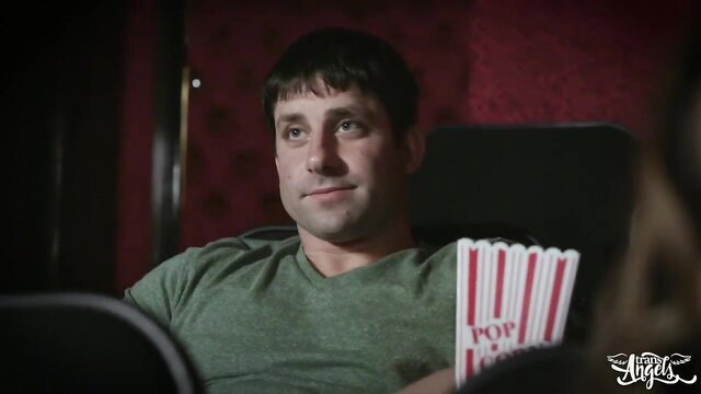 Handsome man with popcorn in dark theater, lustful shemale tease