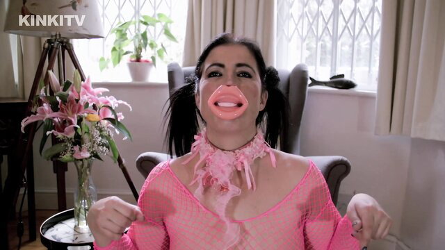 Montse with huge lips in pink fishnet dress and pigtails on Kinkitv PetGirls