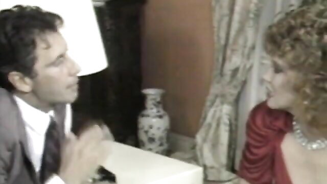 Vintage 80s couple in suit and red dress intimate talk